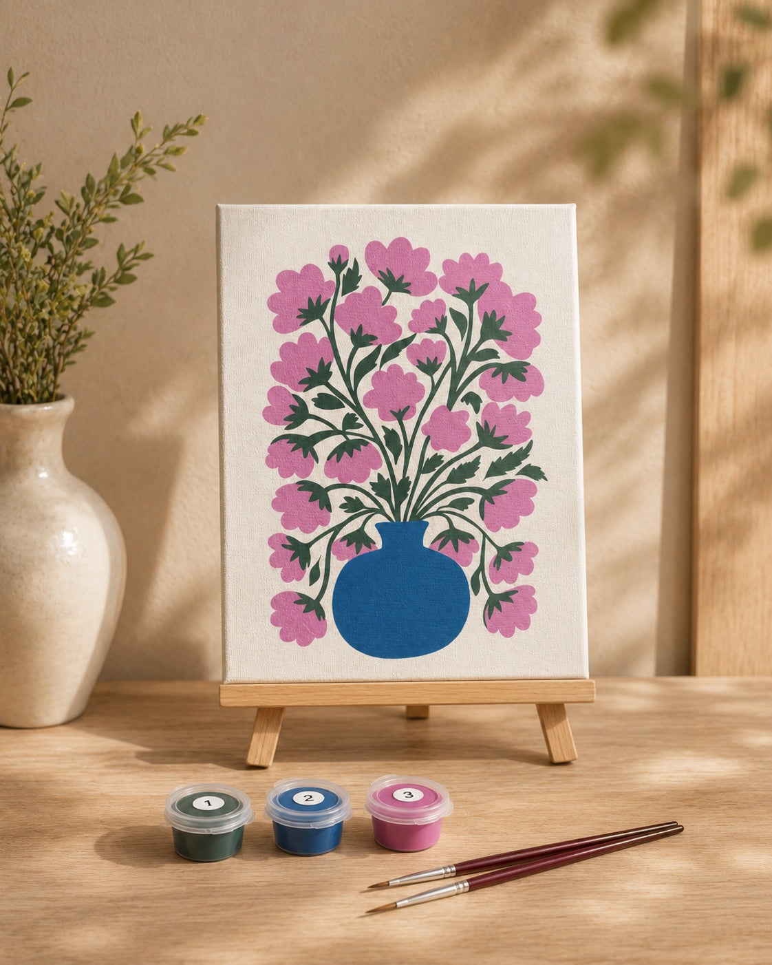 Finished EasyArt.ae floral canvas with paints and brushes